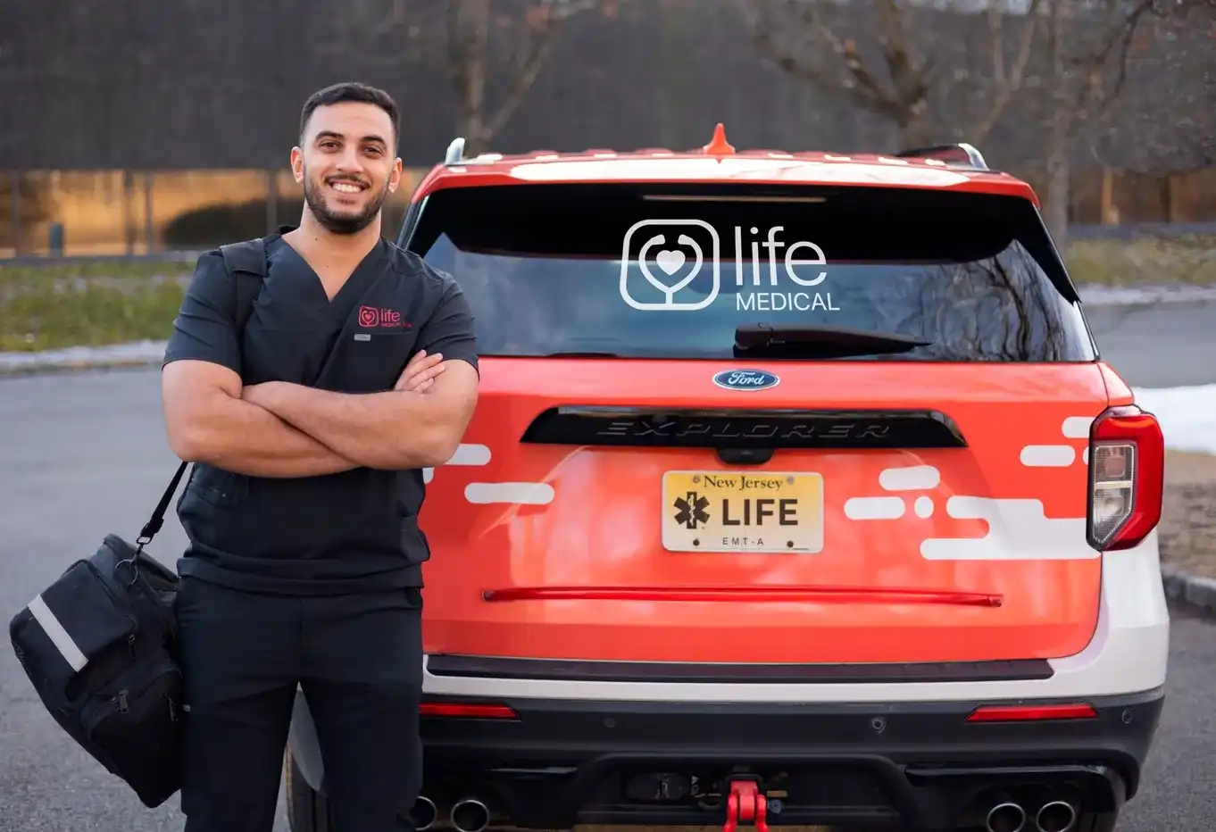 Mobile urgent care provider standing next to Life Medical car