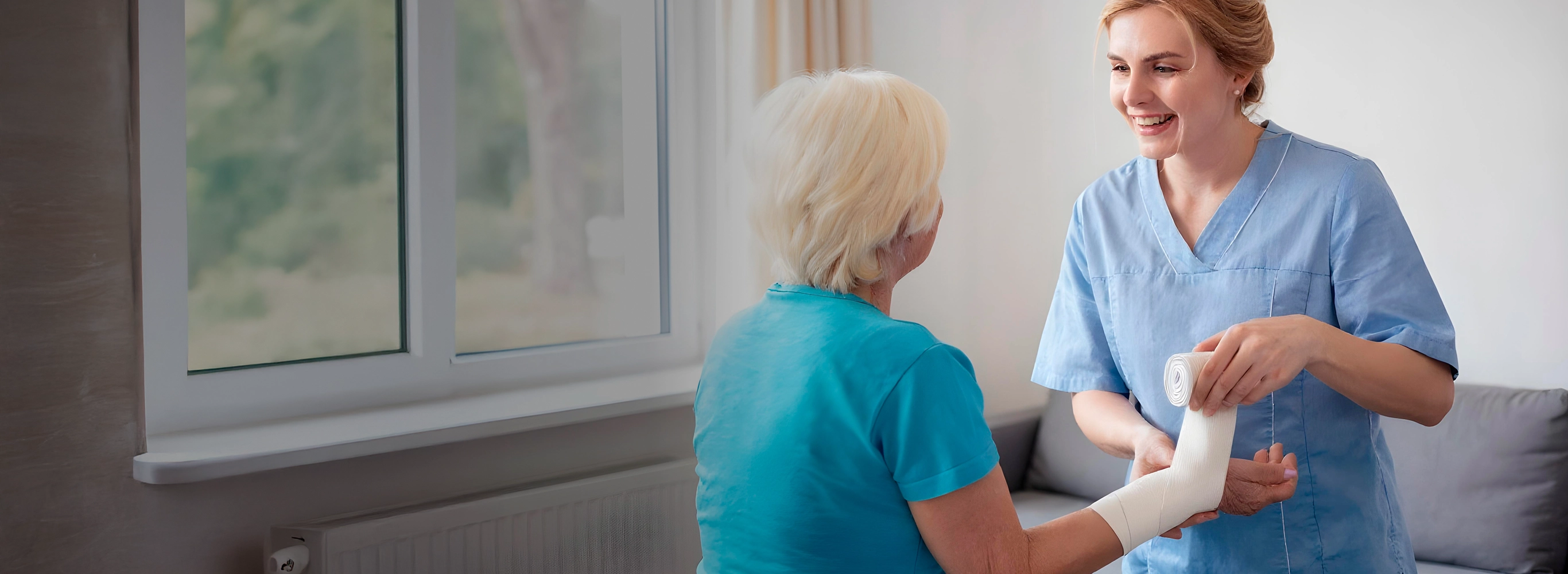 Nurse providing in-home wound care to senior patient
