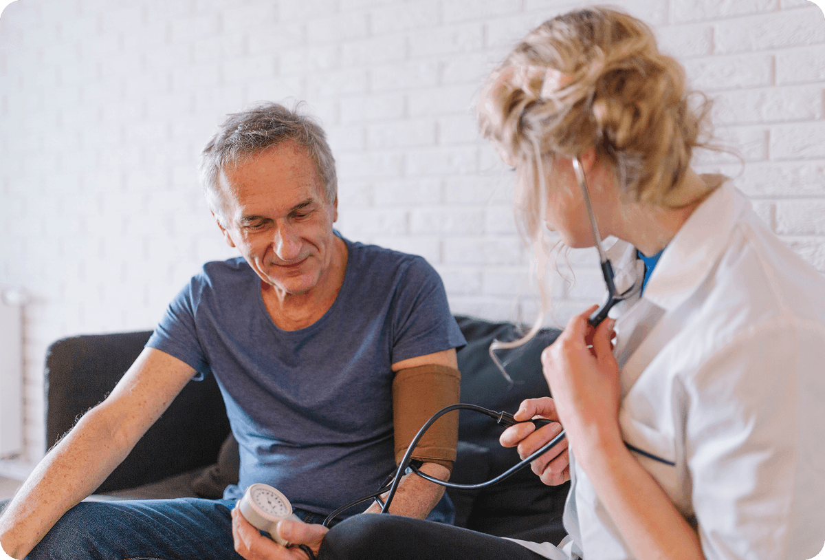 Primary care physician listening to a patient during an office visit.