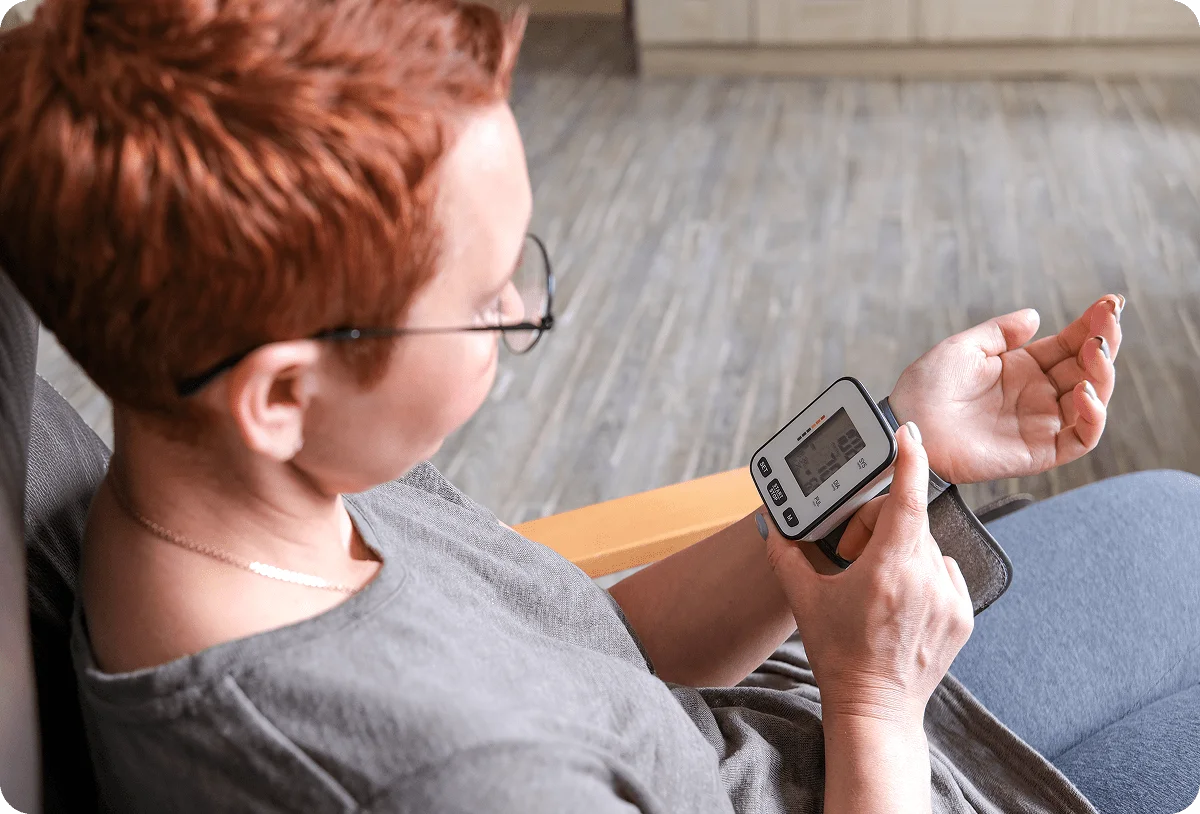 Young woman with short hair recording blood preassure